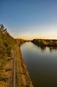 Scenic view of river against sky at sunset