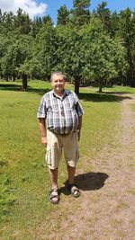 Full length of young man standing on field