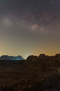 Scenic view of landscape against sky at night