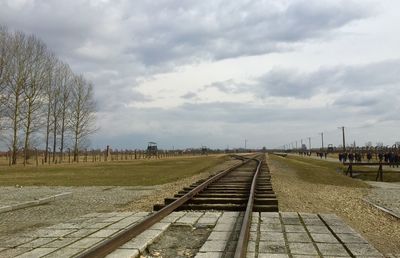 View of railroad tracks against cloudy sky