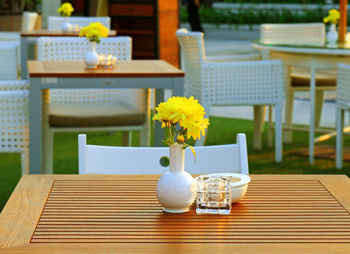 White flower vase on table at restaurant