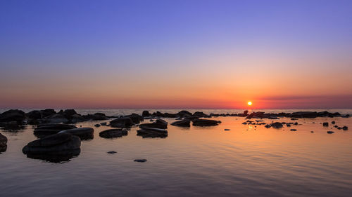 Scenic view of sea against sky at sunset