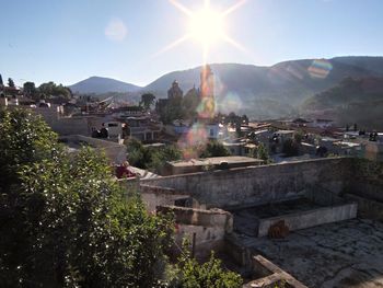 Townscape by mountains against sky