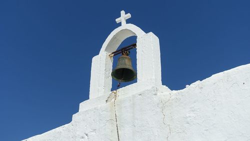 Low angle view of cross against clear blue sky