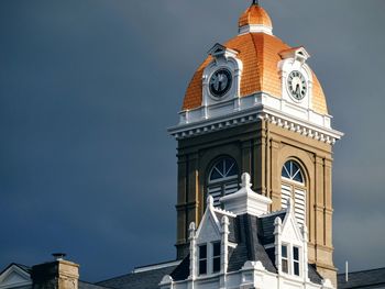 Low angle view of clock tower against clear sky