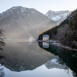 Scenic view of lake by snowcapped mountains