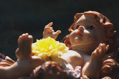 Close-up of flowers on statue