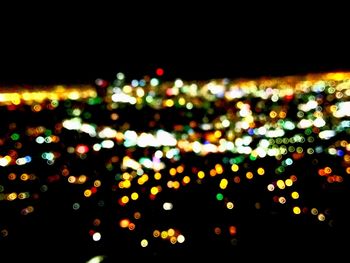 Close-up of illuminated lights against black background