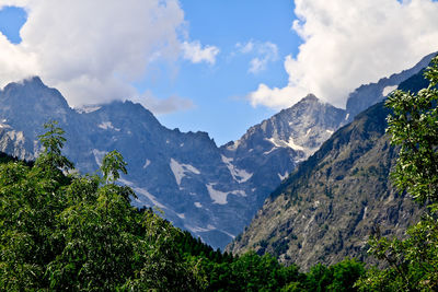 Scenic view of mountains against cloudy sky