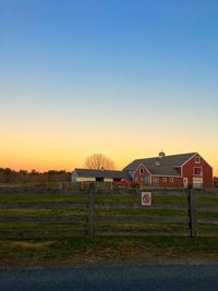 Scenic view of grassy field against clear sky