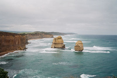 Rocks in sea against sky
