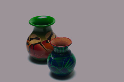 Close-up of glass bottle on table against white background