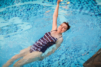 High angle view of woman swimming in pool