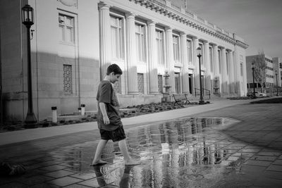 Boy standing against nebraska state capitol building 