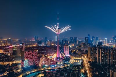 Illuminated city against clear sky at night