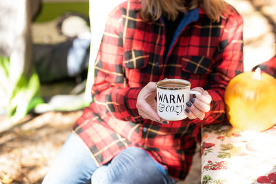 Midsection of woman holding ice cream