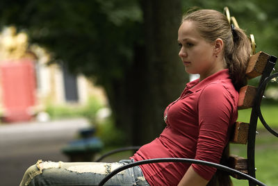 Side view of young woman riding bicycle