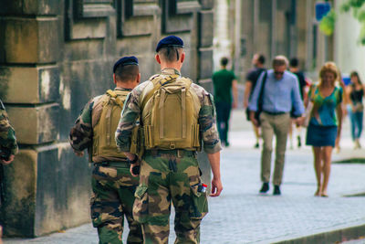 Rear view of people walking outdoors