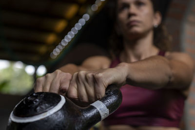 Cropped hand of man exercising in gym