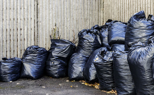 Close-up of garbage can on footpath