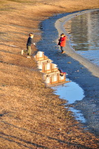 Rear view of woman standing by waterfall