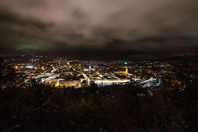 Illuminated cityscape against sky at night