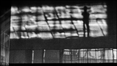 Shadow of person on railing