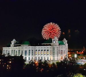 Low angle view of firework display at night