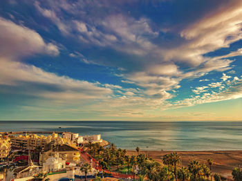 High angle view of townscape by sea against sky