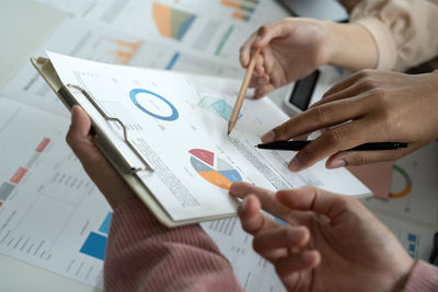 Cropped image of business colleagues working on table