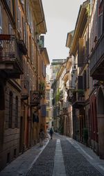 Narrow street amidst buildings in city