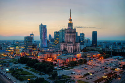 High angle view of buildings in city during sunset