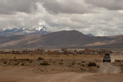 Scenic view of mountains against cloudy sky