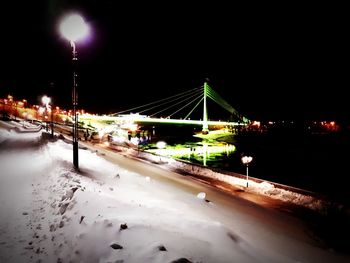 Illuminated city against clear sky at night