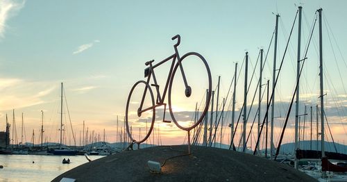 Sailboats in harbor at sunset