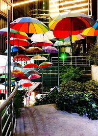 Colorful umbrellas hanging on railing
