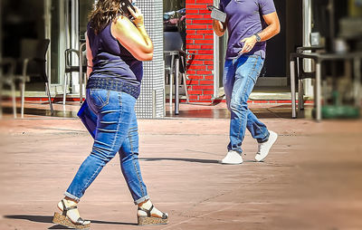 Low section of man and woman on footpath