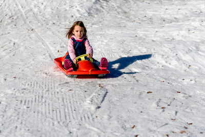 Portrait of a girl sledding