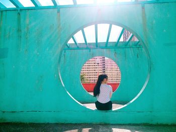 Rear view of woman on wall