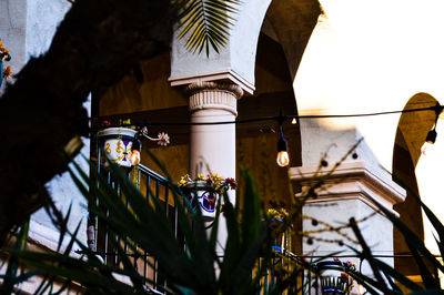 Low angle view of illuminated lamp by building