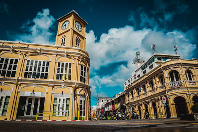 Low angle view of building against cloudy sky