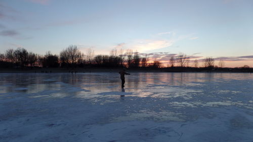 Scenic view of frozen lake against sky during winter