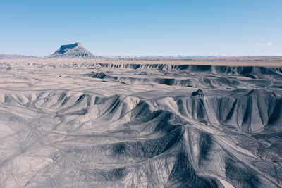 Aerial view of off-road atv tracks of swing arm city in torrey, utah. factory butte in distance.