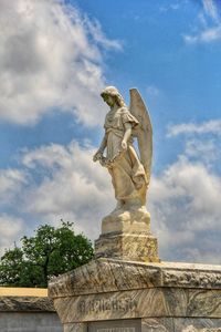 Low angle view of statue against cloudy sky