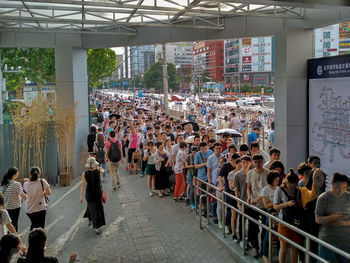 High angle view of people standing by buildings in city