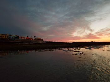 Scenic view of beach against sky during sunset