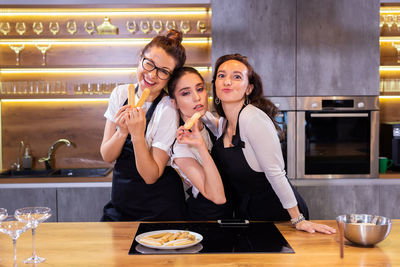 Portrait of female friends sitting at restaurant