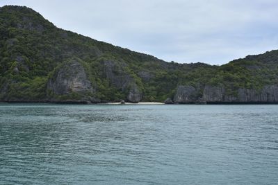 Scenic view of sea and mountains against sky