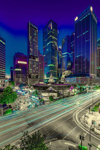 High angle view of illuminated city street and buildings against sky