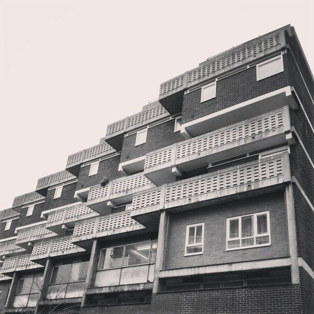 architecture, building exterior, built structure, low angle view, window, clear sky, building, residential building, residential structure, city, day, apartment, sky, balcony, outdoors, no people, modern, office building, repetition, in a row